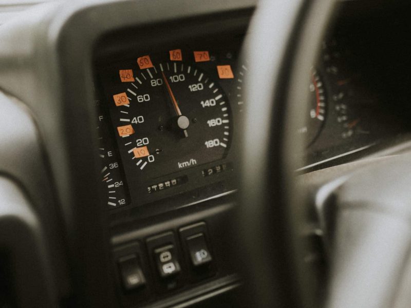 Car steering wheel and labeled speedometer Car steering wheel and labeled speedometer